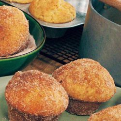 Recipe for Baked Doughnut Muffins - They may look like muffins, but a dunk in melted butter and a roll in cinnamon-sugar makes these luscious morsels taste more like donuts, without the hassle of deep-frying