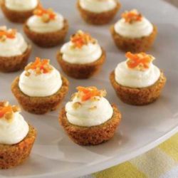 Pile on the frosting! Our homemade, cream cheese icing makes these Mini Carrot Cake Cups irresistible!