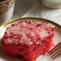 This Spring Strawberry Sheet Cake is a symbol of spring. The pink cake with pink frosting is a fan favorite any time of the year. The cold dessert with flecks of strawberry is at its best the longer it is refrigerated.