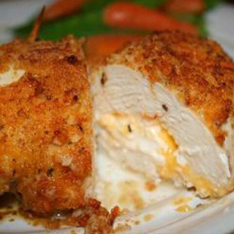Not your everyday chicken dish! Stuffed with Cheddar and cream cheeses, then drenched with a garlic-lemon-butter sauce, your friends and family will be begging you to make this Garlic Lemon Double Stuffed Chicken recipe time and time again!