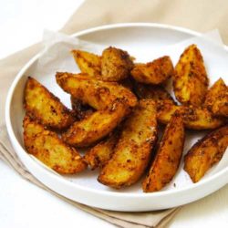 These oven baked Parmesan Potato Wedges are perfectly crisp and tasty. The potatoes are tossed together with Parmesan cheese before baking.