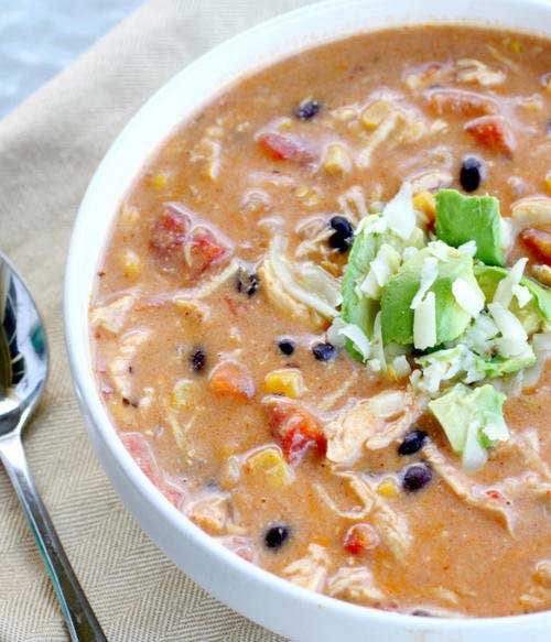 Recipe for Crock Pot Chicken Enchilada Chowder - As if you could make this soup any easier, here’s a little time saving trick I use to shred the chicken. Once you have your warm cooked chicken, simply place it in a bowl, and with a hand mixer beat the heck out of it. It surprisingly shreds with ease in under 30 seconds. You will never shred chicken by hand again.