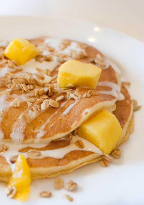 Recipe for Mango Blisscakes - Mango Blisscakes are just what they sound like — a stack of the fluffiest buttermilk pancakes you’ve ever tried, topped with fresh mango, creamy vanilla mascarpone cream and a brown sugar oat crust. Pure heaven.