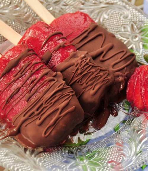 Recipe for Chocolate Dipped Strawberry Popsicles - What is there not to like – luscious sweet strawberries, mashed up, and frozen on a stick. Then dip them chocolate! – Oh my children of all ages (and adults) will love these!