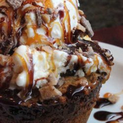 Recipe for Ooey Gooey Toffee Cake - Sweet, buttery cake filled with chocolate chips and Heath toffee, then topped with vanilla ice cream, chocolate and caramel syrups, and even more Heath bits. That’s what you’ll find in Liberty Tree Tavern’s Ooey Gooey Toffee Cake. Enjoy!