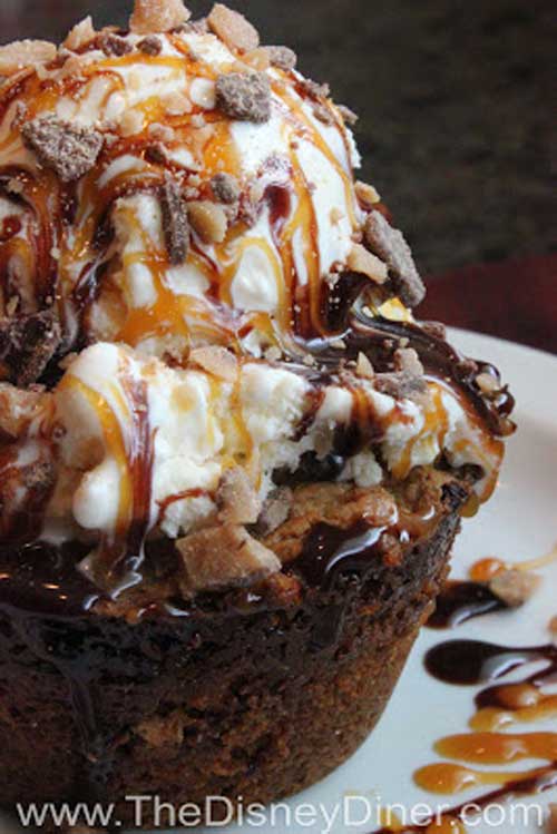 Recipe for Ooey Gooey Toffee Cake - Sweet, buttery cake filled with chocolate chips and Heath toffee, then topped with vanilla ice cream, chocolate and caramel syrups, and even more Heath bits. That’s what you’ll find in Liberty Tree Tavern’s Ooey Gooey Toffee Cake. Enjoy!