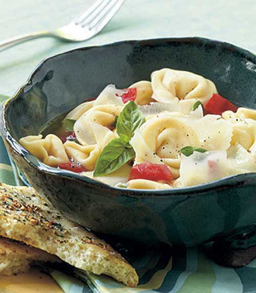 Recipe for Asiago Tortellini - When boiling water for the pasta, start with hot tap water and cover the pot with a lid. This is a surefire way to speed up your cook time. Serve this pasta dish with Black Pepper–Garlic Flatbread to soak up the basil-infused broth.