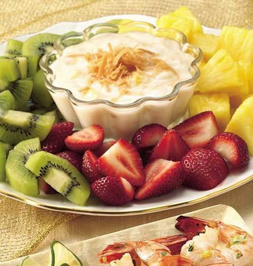 Recipe for Fruit with Pina Colada Dip - Take a trip to the islands with this fun fruit dessert, with kiwis and more dipped in a rum-and-coconut yogurt.