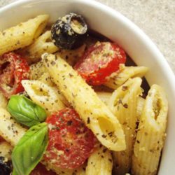 What do you get when you coat penne pasta in a flavorful pesto and toss it with minced garlic, cherry tomatoes, and black olives?