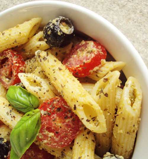 What do you get when you coat penne pasta in a flavorful pesto and toss it with minced garlic, cherry tomatoes, and black olives?
