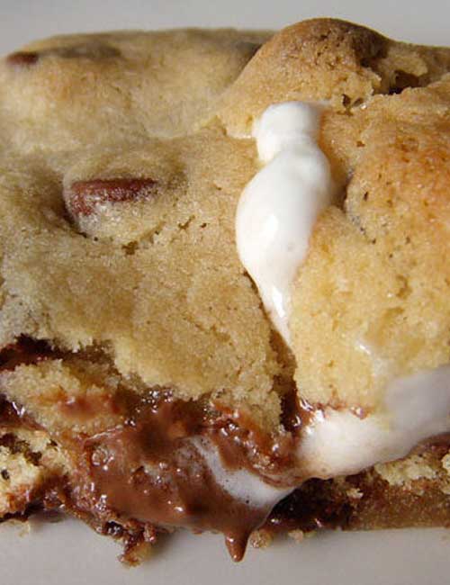 Recipe for Smores Stuffed Chocolate Chip Cookies - Have you ever seen a more delicious-looking cookie?! Me neither. And I’ve seen lots of cookies. These are chocolate chip cookies STUFFED WITH S'MORES. It's a cookie within a cookie! I don't understand why no one thought of this sooner.