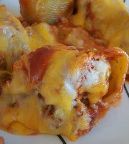 This recipe for Taco Stuffed Shells isn't your ordinary stuffed shell recipe but man is it delicious. The meat is mixed with cream cheese, stuffed inside the shell, and topped with taco sauce and cheese. SOOOOO good!