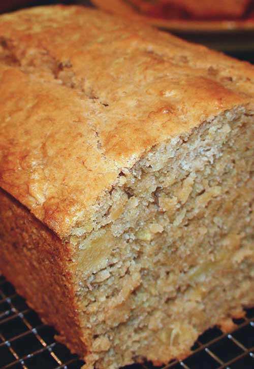 Recipe for Tropical Pineapple Coconut Banana Bread - I’ve made many kinds of banana bread recipes, but this remains my absolute favorite. It’s also one of the more popular recipes on my blog. If you’re looking for a very moist, dense cake with loads of bananas… this is your recipe. Add some extra tropical flavors like pineapple, cream of coconut and macadamia nuts and you’ll be in heaven!