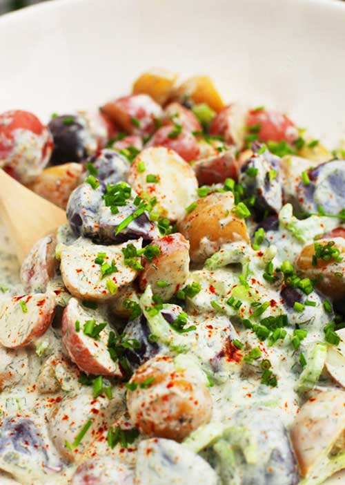 Recipe for Yogurt Dill Potato Salad - Most potato salad recipes use mayonnaise, but today I am sharing a variation using Greek non-fat plain yogurt. Using yogurt adds a slight creamy tang to the potatoes which I absolutely love.