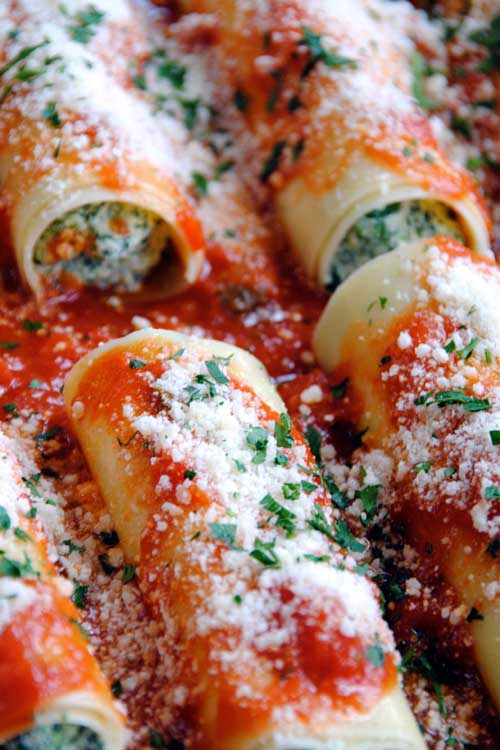 These manicotti are filled with a blend of ricotta, mozzarella and fresh spinach then topped with a tomato basil sauce and Parmigiano-Reggiano for a cheesy, flavorful dish that will wow your dinner guests.