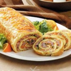 This brunch dish has wonderful ingredients and an impressive look all rolled into one! I love hosting brunch…and this special omelet roll is one of my very favorite items to prepare and share.