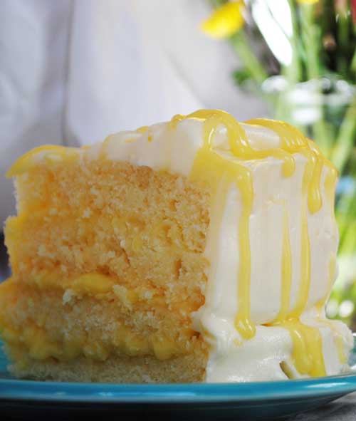 Recipe for Lemon Pucker Cake - Moist, buttery lemon cake filled with tangy lemon curd and encased in the perfect foil of sweetness, a decadent white chocolate buttercream.