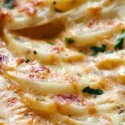 These scalloped potatoes are made with broth, not milk, and get extra flavor from sun-dried tomato pesto. They are fabulous with roast chicken.