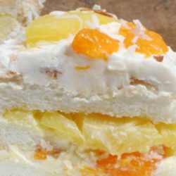 An angel food cake with lots of fresh flavor. The pineapple, mandarin oranges, and toasted coconut give this cake recipe a tropical flair.