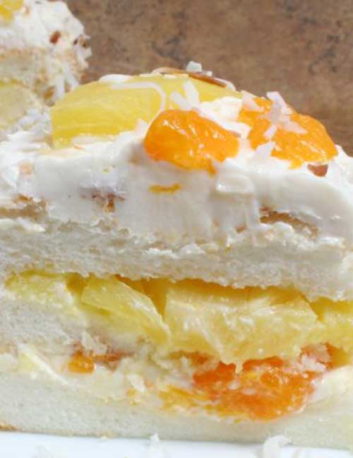 An angel food cake with lots of fresh flavor. The pineapple, mandarin oranges, and toasted coconut give this cake recipe a tropical flair.
