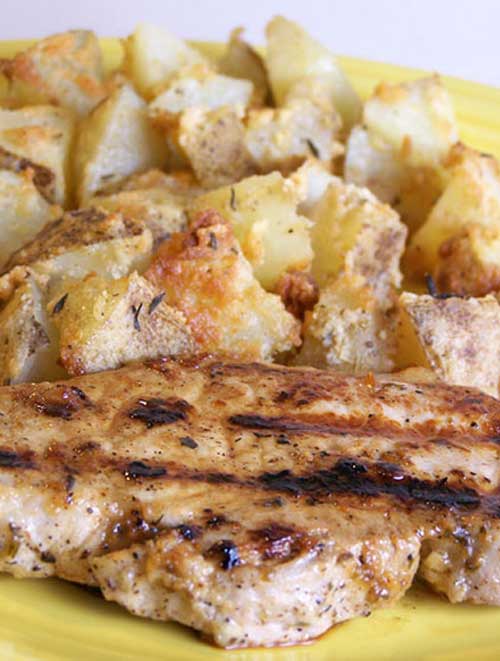Recipe for Grilled Lemon Herb Pork Chops with Parmesan Roasted Potatoes - Pork and potatoes is such a classic combination. And with this pair of recipes, you will find out why, in such a yummy way.