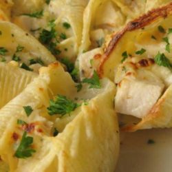 Recipe for Chicken Alfredo Stuffed Shells - These pasta shells, filled with warm, gooey cheese, are always popular. The tender chicken and rich sauce make the dish so satisfying, you may just not be able to make enough of them!