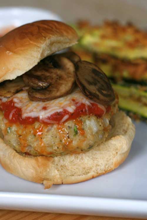 Recipe for Chicken Parmesan Burgers - Get out of your burger rut with these ground chicken parmesan burgers. Grill then serve on ciabatta rolls and top with marianara sauce and mozzarella.