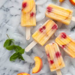 Recipe for Peach Sangria Popsicles - Enjoy a refreshing spin on fruit-filled cocktails with a recipe for no sugar added Peach Sangria Popsicles!