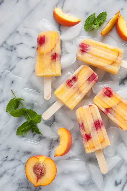 Recipe for Peach Sangria Popsicles - Enjoy a refreshing spin on fruit-filled cocktails with a recipe for no sugar added Peach Sangria Popsicles!