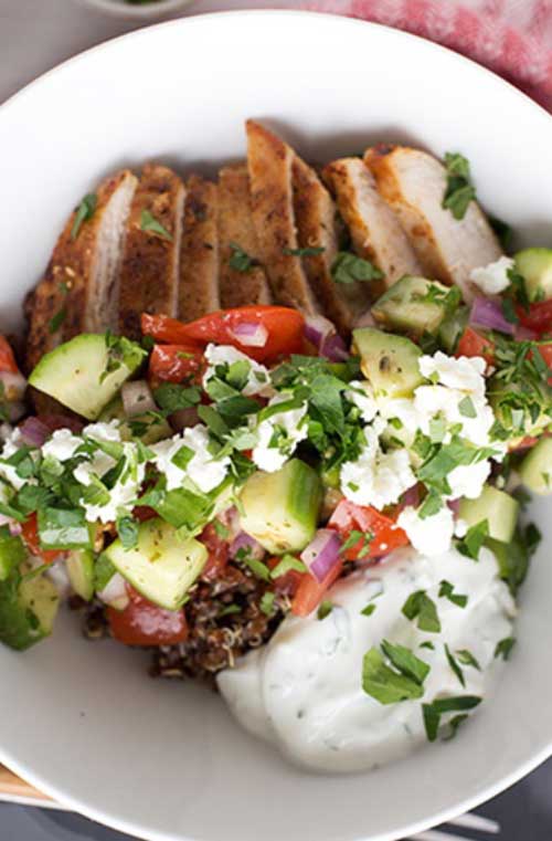 These Greek Chicken Quinoa Bowls are a quick and healthy meal to prepare for the family. This dinner has it all - whole grains, vegetables, lean protein and a light yogurt sauce.