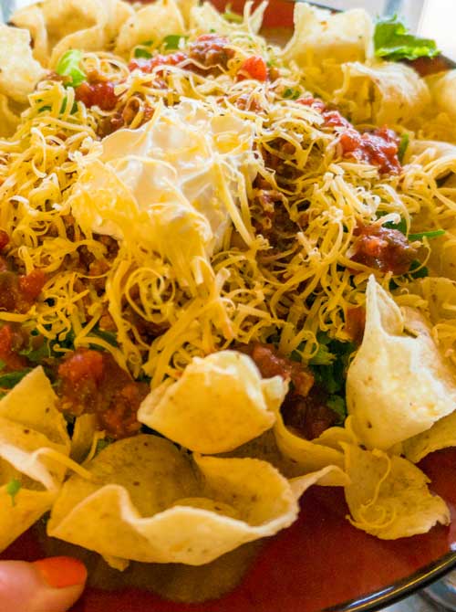 Recipe for Deli Style Taco Salad - The chili is cooked in the crockpot and the rest of the taco salad just takes a few minutes to create so it’s pretty easy!