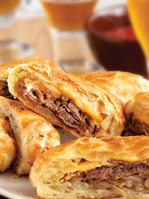 Recipe for Philly Cheesesteak Rolls - These upscale cheesesteak sandwiches feature flaky puff pastry instead of ordinary rolls. They're easy to make, and even easier to enjoy!