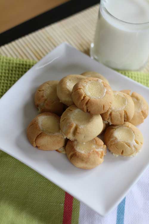 Recipe for Cheesecake Thumbprint Cookies - The crunchiness of a cookie and the creaminess of cheesecake all in one decadent little cookie. These may prove to be a hazard to your waistline.