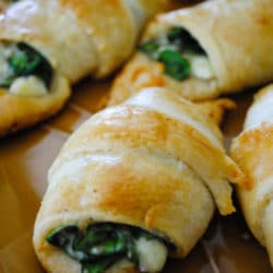 Melted cheese and spinach stuffed into a light and fluffy crescent roll! Not only are these cheesy spinach crescent rolls perfect for when you need dinner in a hurry, they also make the perfect snack or appetizer.
