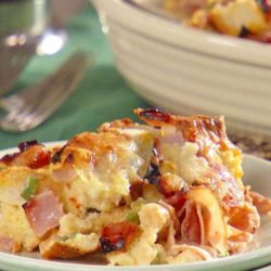 Recipe for Ham and Cheese Strata - This hearty make-ahead breakfast is infused with Dijon mustard and bakes up to a fluffy, golden finish.