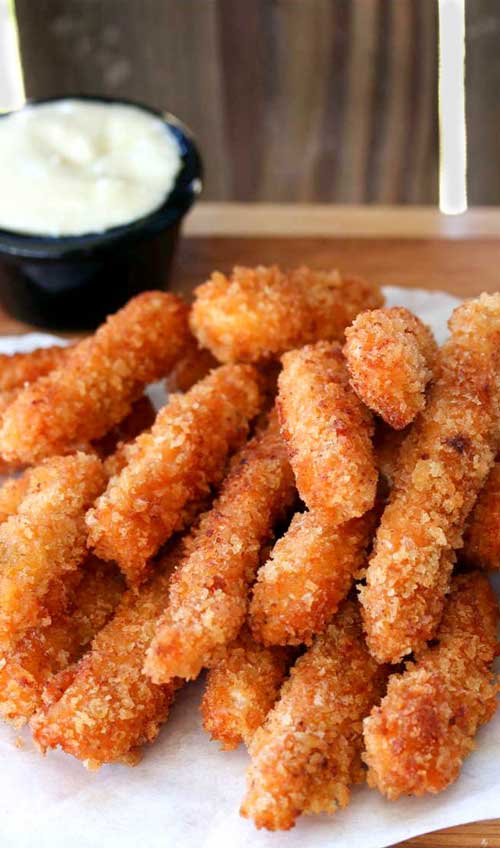 Recipe for Buffalo Chicken Fries - Crispy chicken fries with a hint of zesty buffalo sauce, perfect for dipping into fresh bleu cheese.