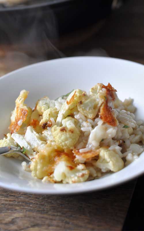 Recipe for Roasted Cheesy Cauliflower Risotto - Texture and flavor all rolled into one bubbling pan of arborio. Caramelised, cheesy bits in the roasted parts, and the soft, flavor-soaked bits care of the risotto.