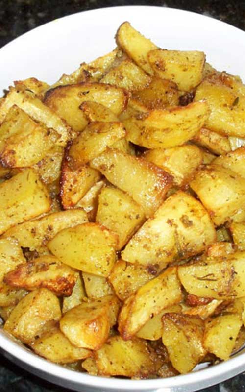 Recipe for Oven Roasted Garlic Potatoes - These roasted potatoes have become a family favorite. The potatoes roast slowly in a bath of lemon and olive oil, soaking up all the garlic-y goodness!