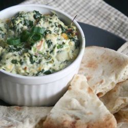 Recipe for Copycat Applebee's Spinach and Artichoke Dip - A delicious blend of mozzarella, parmesan, and romano cheeses, combined with spinach and artichoke, makes this a killer copycat recipe!
