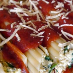 Recipe for Stuffed Spinach & Mushroom Manicotti - Bring on the wow factor with this traditional pasta dish. This spinach and mushroom manicotti recipe only looks like it takes a lot of effort to make!