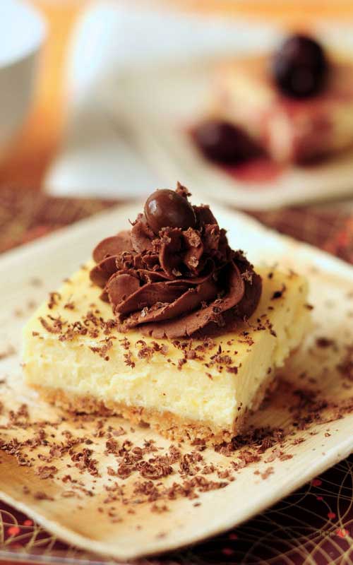 Recipe for Zabaglione Cheesecake - A rich, smooth, and delightful cheesecake combination set on an almond crumb base and glazed with a decadent trufle fudge frosting.