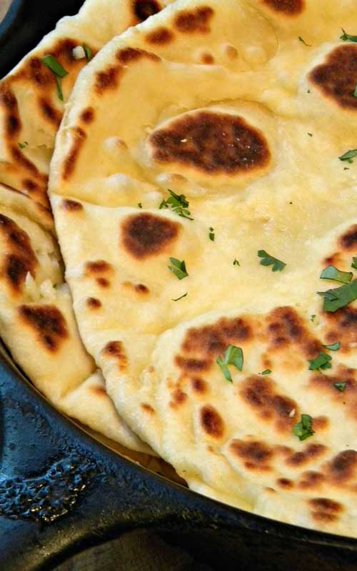 Recipe for Garlic-Butter Naan - The aroma of fresh cooking garlic naan slathered in warm garlic-butter is mouth-watering! Perfect for garlic lovers and Indian Cuisine Fanatics!