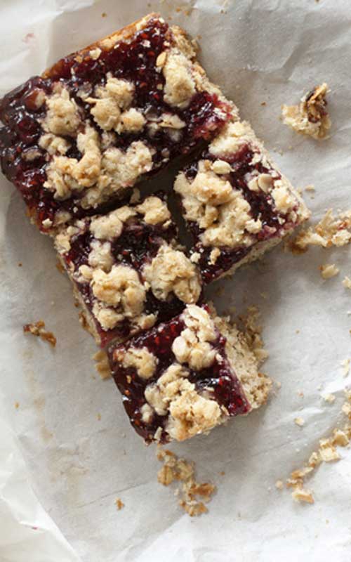Recipe for Raspberry Oat Crumble Bars - These bars bake up into three layers of shortbread goodness, sweet raspberry, and buttery crumble. They taste like brown sugar and old-fashioned oats, with a healthy smear of jam oozing out the middle.