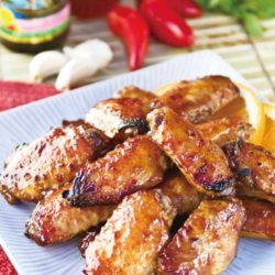 Recipe for Spicy Chicken Wings with Sriracha Chili Sauce - No Superbowl party food table would be complete without BBQ wings, and we simply love this spicy chicken wings recipe. And, they're easy to make!
