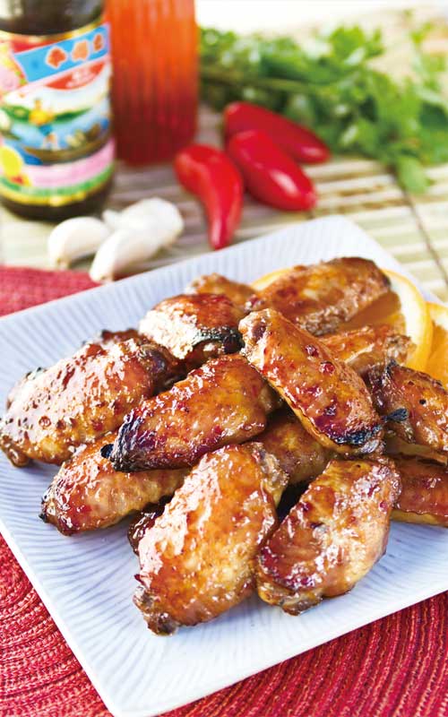 Recipe for Spicy Chicken Wings with Sriracha Chili Sauce - No Superbowl party food table would be complete without BBQ wings, and we simply love this spicy chicken wings recipe. And, they're easy to make!