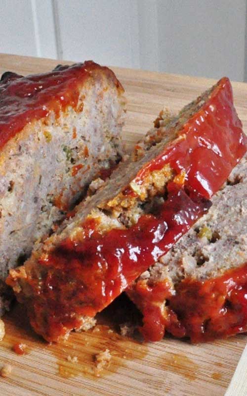 Close up view of a meatloaf that has been cut into slices.