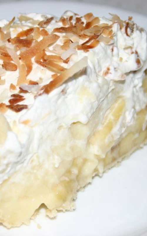Recipe for Banana Cream Pie - This fluffy banana cream pie recipe is piled high with fresh ripe bananas and creamy vanilla filling, then topped with pillowy whipped cream and toasted coconut.