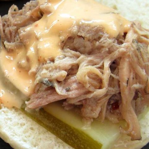 Recipe for Kalua Pork Sliders with Sriracha Aioli - This is a classic Hawaiian dish. And if don't have a pig pit in the back yard, a slow cooker will do the trick just fine.