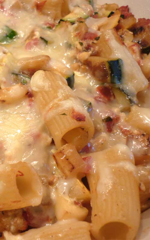 Recipe for Baked Ziti and Summer Vegetables - Add some pops of color to this simple baked ziti using summer veggies like tomatoes, squash, and zucchini.