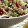 Recipe for Mediterranean Quinoa Salad - What a party of flavor! A tasty side salad featuring quinoa and a colorful variety of vegetables. Feta cheese and a light lemon dressing complete the Mediterranean Quinoa Salad.